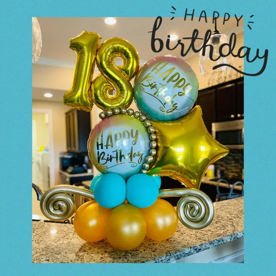 A gold and pastel balloon bouquet with a number 18 and Happy Birthday balloons on a kitchen counter.