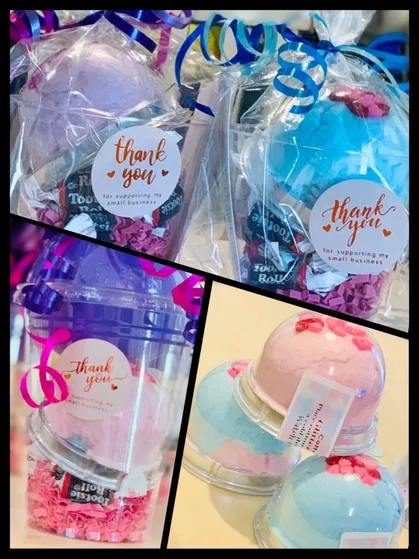 Domed cups of pink and blue cotton candy with sweets underneath and a thank-you tag tied on top.